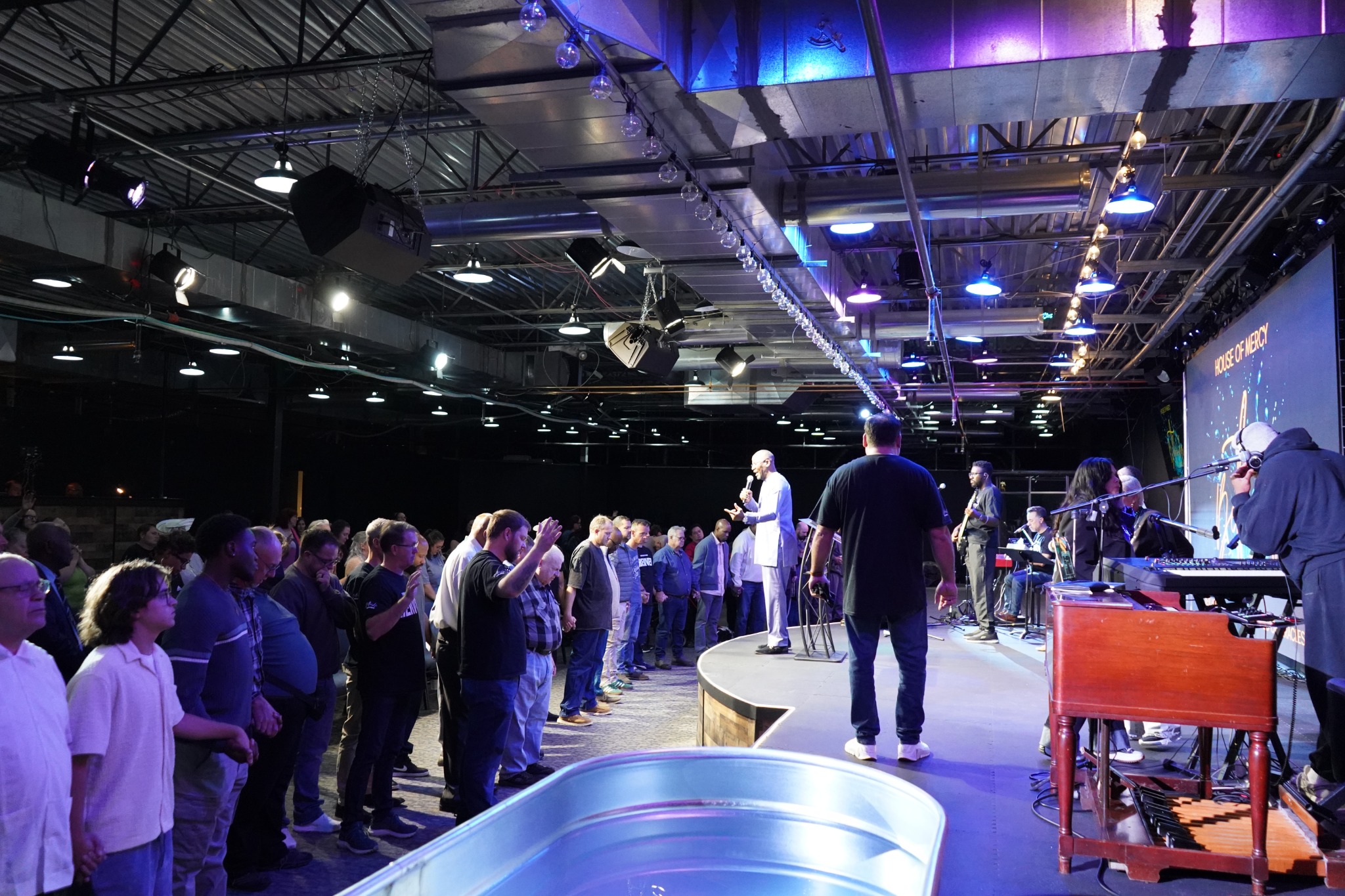 The church family gathered for prayer beside the worship stage.