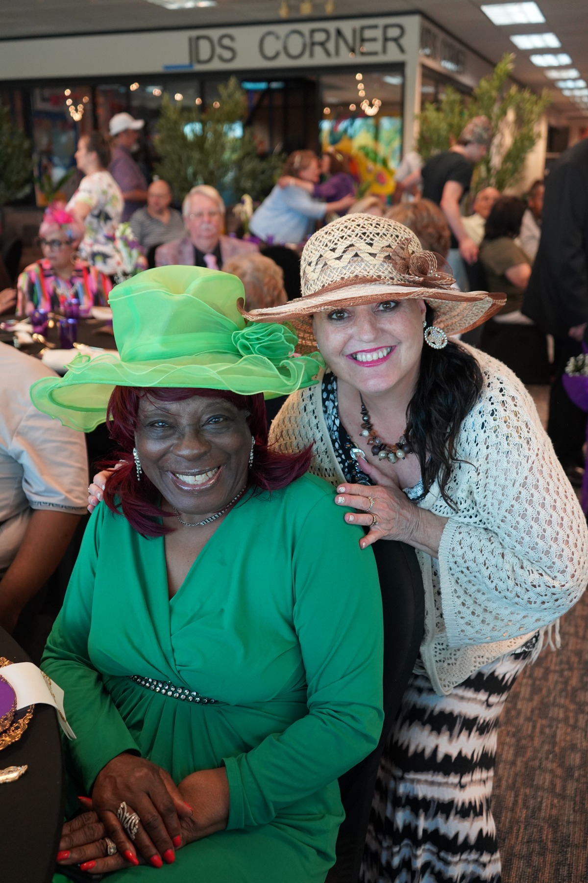 Two older women smiling together at a Bethesda church gathering.
