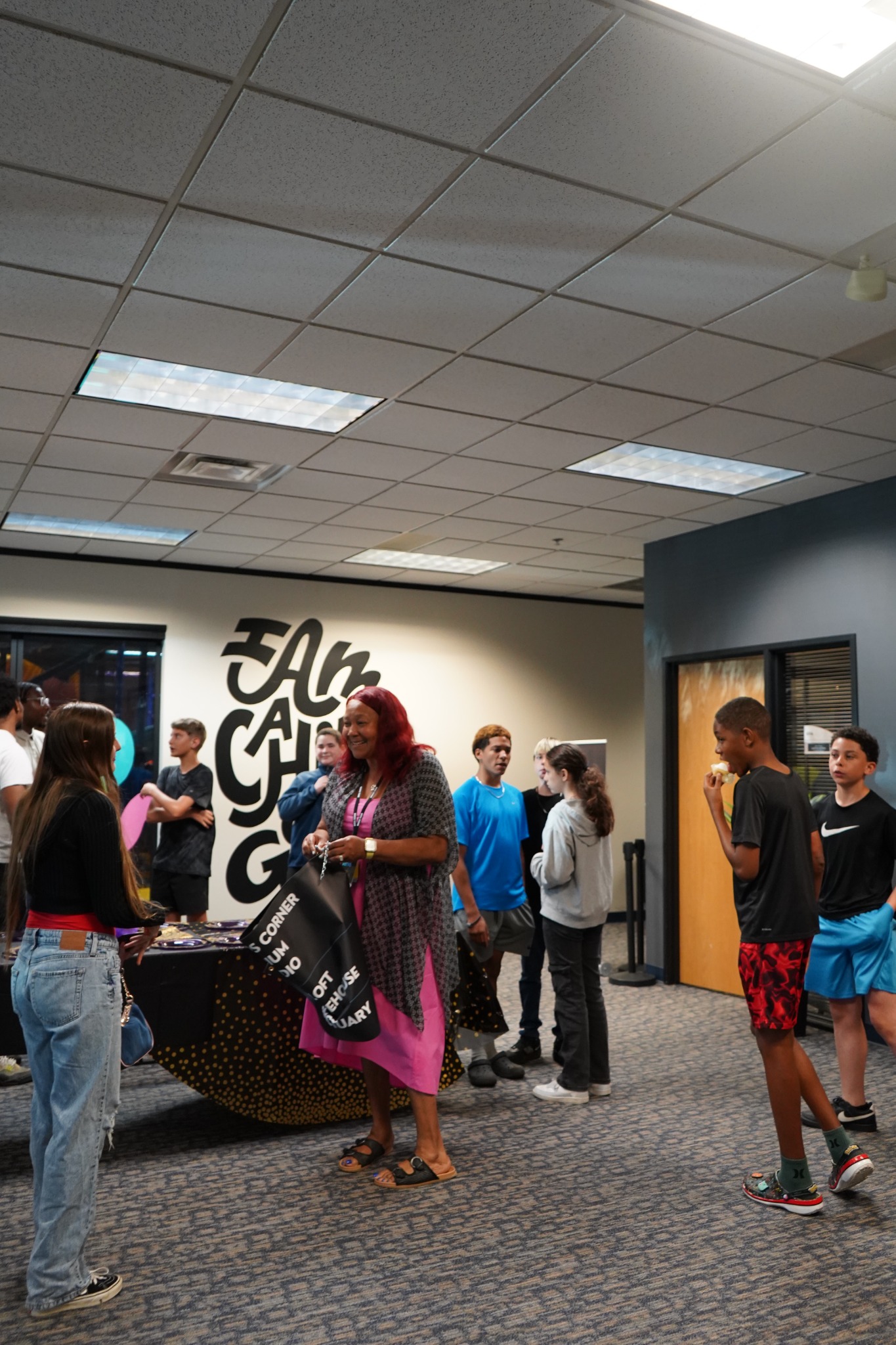 Youth and an adult sharing conversation at church.